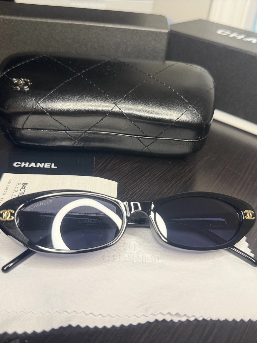 CHANEL Black Oval Sunglasses with Gold CC Accents